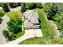 Aerial view of the property highlighting the well manicured yard, multiple car garage and basketball court at 9669 E Prentice Cir, Greenwood Village, CO 80111