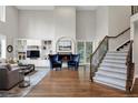 Bright living room with hardwood floors, a cozy fireplace, and large windows for natural light at 9669 E Prentice Cir, Greenwood Village, CO 80111