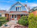 Charming two-story home with a blue and red brick exterior, a covered porch, and well-maintained landscaping at 3361 W 29Th Ave, Denver, CO 80211