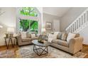 Bright living room with high ceilings, large windows, neutral decor, comfortable seating, and hardwood floors at 156 S Lindsey St, Castle Rock, CO 80104