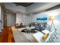 Open-concept living area featuring hardwood floors, chic decor, and great natural light at 1700 Bassett St # 1119, Denver, CO 80202