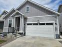Charming gray home showcasing a two-car garage and a welcoming covered front porch at 27853 E 8Th Ave, Aurora, CO 80018