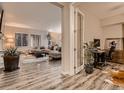 Open-concept living space showcasing wood floors, office space, and abundant natural light at 6894 E 133Rd Pl, Thornton, CO 80602