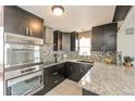 Well-equipped kitchen boasting granite counters, stainless steel appliances, and ample cabinet space at 1125 Newark St, Aurora, CO 80010