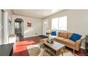 Inviting living room with a comfortable couch, stylish coffee table, and ample natural light at 1125 Newark St, Aurora, CO 80010