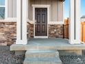 Close-up of a front door with columns and stone veneer, showcasing the entrance to a well-maintained home at 259 E 4Th St, Berthoud, CO 80513