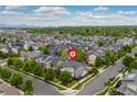 Stunning aerial view of a residential neighborhood with tree-lined streets and mountain views at 1813 W 67Th Ave, Denver, CO 80221