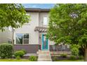 Charming two-story home boasting a bright turquoise door, covered entrance, and lush landscaping at 1813 W 67Th Ave, Denver, CO 80221