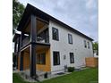 Side view of a modern two-story home with a well-maintained lawn and minimalist landscaping at 2405 S Franklin, Denver, CO 80210