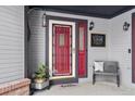 Inviting front entrance with red door and welcoming decor at 10810 W 63Rd Ave # C, Arvada, CO 80004