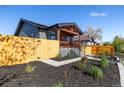 Landscaped exterior featuring a fence, green plants, and pathway at 15 Hazel Ct, Denver, CO 80219