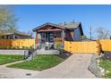 Beautiful front exterior features landscaped yard and a well-maintained lawn at 15 Hazel Ct, Denver, CO 80219
