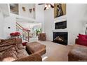 Bright living room features a fireplace, plush furnishings, and large windows with great natural light at 4056 Perth St, Denver, CO 80249
