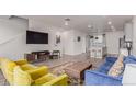 Stylish living room featuring hardwood floors, a comfortable blue sofa, and an open layout with natural light at 1918 W 165Th Way, Broomfield, CO 80023