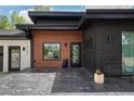 Modern home featuring wood and black exterior accents and stylish front entrance at 6260 Lamar St, Arvada, CO 80003