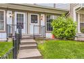 Inviting front entrance with steps, railing, and manicured lawn at 1811 S Quebec Way # 31, Denver, CO 80231