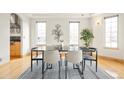 Dining room with modern black marble table, patterned rug, and decorative wall art at 1942 Kentmere Dr, Longmont, CO 80504