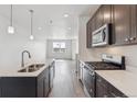Stylish kitchen featuring a central island, stainless steel appliances, and ample counter space at 451 Interlocken Blvd # 104, Broomfield, CO 80021