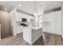 Stylish kitchen presents expansive island, modern appliances, and bright white cabinets, perfect for cooking at 451 Interlocken Blvd # 104, Broomfield, CO 80021