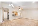 Open-concept living area with a view of the kitchen and a ceiling fan for added comfort at 2043 S Salida St, Aurora, CO 80013