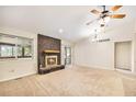 Cozy living room featuring a brick fireplace, ceiling fan, and sliding door to the outside at 2043 S Salida St, Aurora, CO 80013