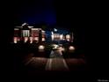 Nighttime view of a beautifully lit brick home with a landscaped front yard and welcoming entrance at 3810 E White Bay Dr, Highlands Ranch, CO 80126