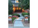 Inviting front entrance with a patterned walkway, illuminated address post and double doors at 3810 E White Bay Dr, Highlands Ranch, CO 80126