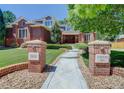 Charming brick home featuring lush landscaping, well-lit walkway, and a manicured lawn at 3810 E White Bay Dr, Highlands Ranch, CO 80126