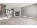 Spacious living room featuring laminate floors and a stunning stone fireplace at 1671 S Idalia Cir # D, Aurora, CO 80017