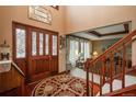 Inviting foyer with hardwood floors, a decorative rug, and a beautiful wood front door at 7965 S Eudora Cir, Centennial, CO 80122