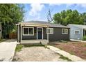 This cozy single-story home boasts an inviting entrance and a simple front yard with an extended driveway for easy access at 1941 Alton St, Aurora, CO 80010