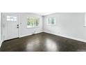 Bright living room with hardwood floors and multiple windows allowing ample natural light at 1941 Alton St, Aurora, CO 80010