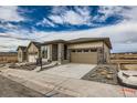 Beautifully designed single-Gathering home boasting stone accents, a spacious driveway, and easy-care landscaping at 454 Basin Daisy St, Castle Rock, CO 80104