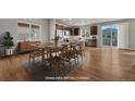Bright dining area featuring a wooden table set on an area rug in an open concept room at 15902 Stringhalt Way, Parker, CO 80134