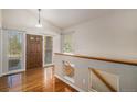 Bright foyer features hardwood floors, a wood door, and an open staircase to the basement at 1660 Moveen Hts, Monument, CO 80132