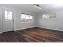 Bright living room featuring dark, wood-look floors, fresh paint, and plenty of natural light at 3745 Fairfax St, Denver, CO 80207