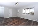 Living room featuring dark wood floors, neutral paint, and modern lighting at 3745 Fairfax St, Denver, CO 80207