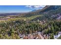 Scenic aerial view of a forest landscape featuring majestic mountains and a sprawling forest at 4835 Abo Ln, Monument, CO 80132