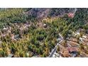An aerial view of a wooded community with scattered homes and winding roads at 4835 Abo Ln, Monument, CO 80132