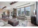 Open living area with stone fireplace and hardwood floors at 1729 Santa Fe Mountain Rd, Evergreen, CO 80439