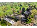 Gorgeous aerial view of the property nestled on a lush golf course with mature trees at 6990 W 9Th Pl, Lakewood, CO 80214