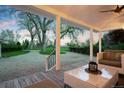 Inviting covered patio perfect for outdoor living with views of the expansive yard at 6990 W 9Th Pl, Lakewood, CO 80214