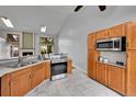 Kitchen featuring stainless steel appliances and classic cabinets with bright tile floors at 4734 S Garland St, Littleton, CO 80123