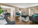 Cozy living room with hardwood floors, comfortable seating, and an adjacent office space at 6660 E Floyd Ave, Denver, CO 80224