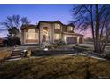 Two-story house with brick and stone exterior; landscaped yard and driveway at 15050 Harrison St, Brighton, CO 80602