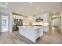 Modern kitchen with stainless steel appliances, a spacious island, and ample cabinet space at 15616 W Beloit Ave, Morrison, CO 80465