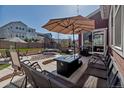 Beautifully designed backyard with a large patio, built-in fire pit, and green space at 4840 Point Mesa St, Castle Rock, CO 80108