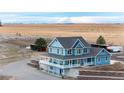 Aerial view of the property, featuring a barn, a home, and scenic views at 52900 E 88Th Ave, Strasburg, CO 80136