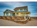 Rear view of beautiful two-story home with walk-out basement and retaining wall at 52900 E 88Th Ave, Strasburg, CO 80136