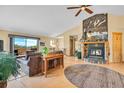 Cozy living room with a stone fireplace, wood floors, and an incredible mountain view at 10786 Marclif Rd, Conifer, CO 80433